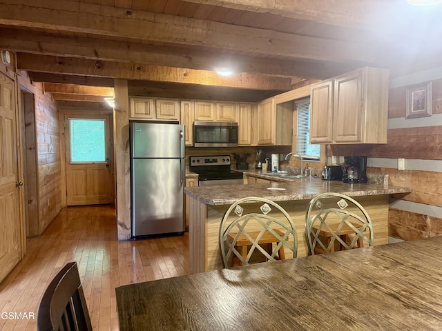 2575 Black Bear Ln, Sevierville, TN 37876 - kitchen with light wood-style flooring, plenty of natural light, a sink, beamed ceiling, and stainless steel appliances