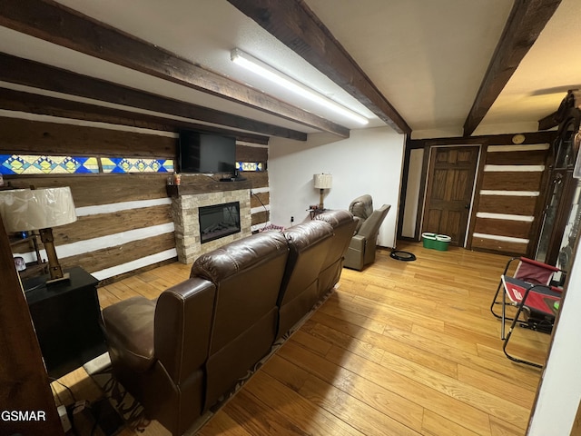 815 Hartsell Rd, Newport, TN 37821 - living area featuring hardwood / wood-style flooring, beam ceiling, a stone fireplace, and wood walls