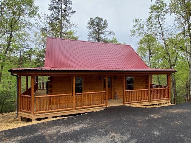 log-style house with covered porch