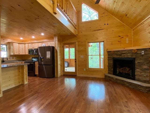 kitchen with fridge with ice dispenser, electric range, wooden ceiling, high vaulted ceiling, and light brown cabinetry