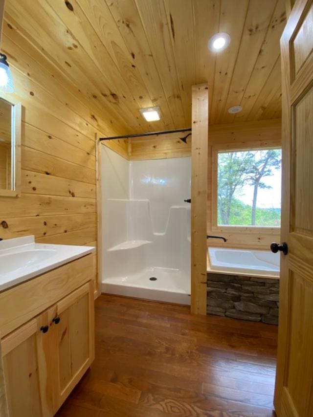 bathroom featuring wood ceiling, separate shower and tub, vanity, and wood-type flooring