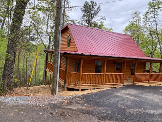 log-style house with a porch