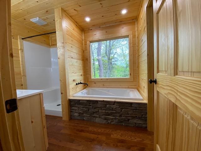 bathroom with wood-type flooring, shower with separate bathtub, wooden walls, and wooden ceiling