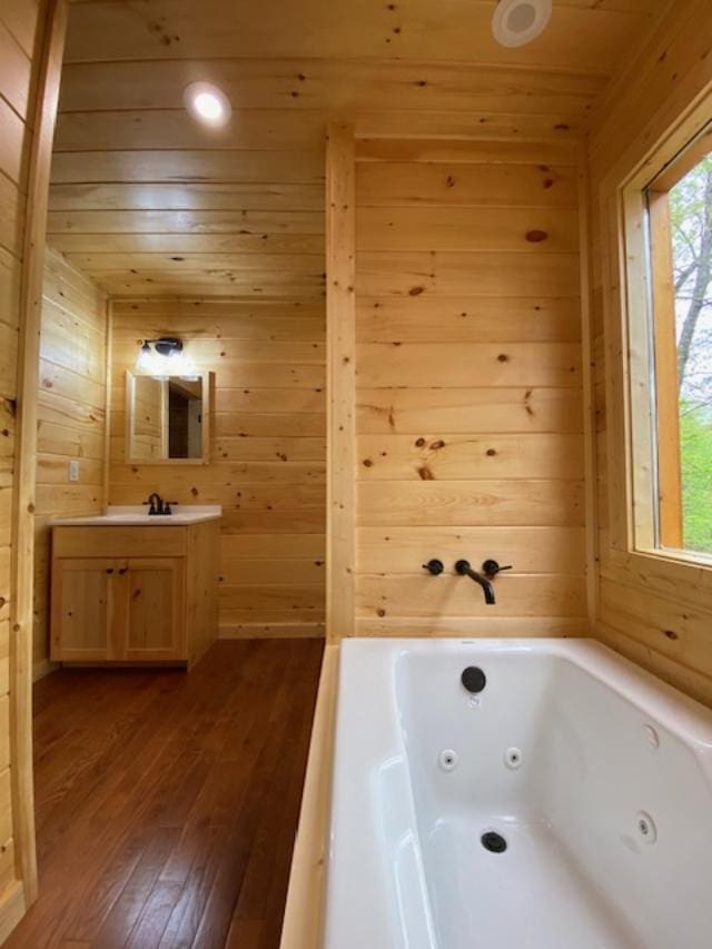 bathroom featuring hardwood / wood-style flooring, a bathtub, and wood walls