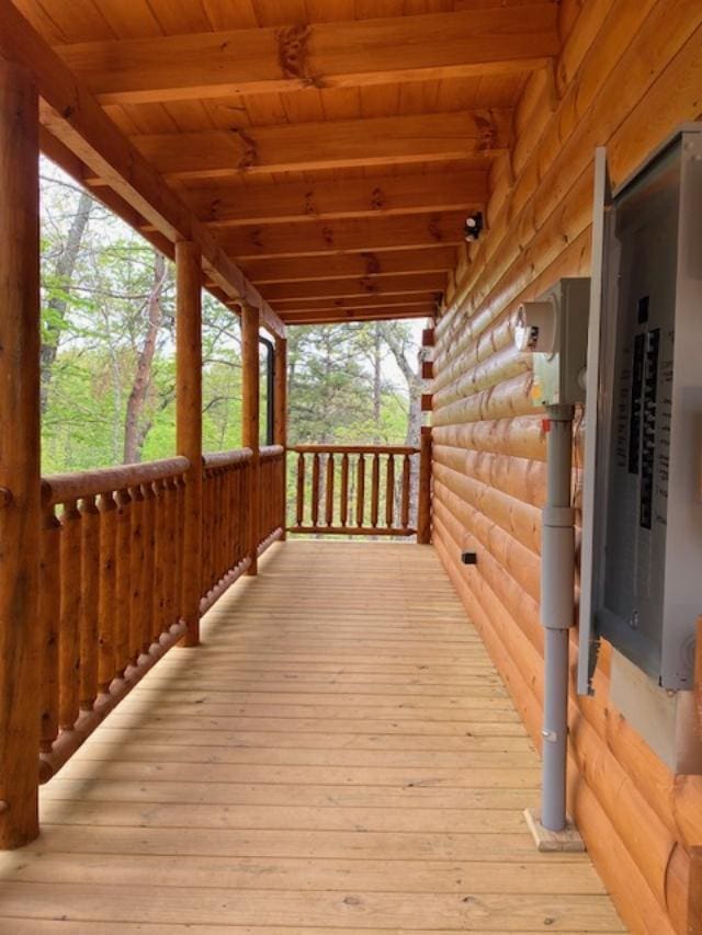 wooden terrace with electric panel and covered porch