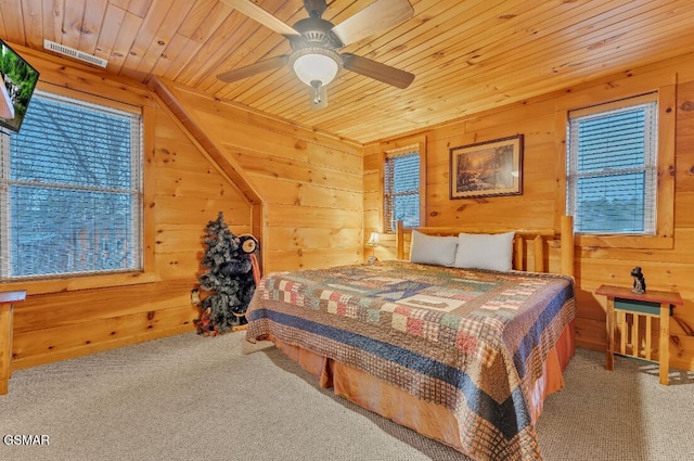 bedroom featuring ceiling fan, wood walls, lofted ceiling, carpet, and wood ceiling