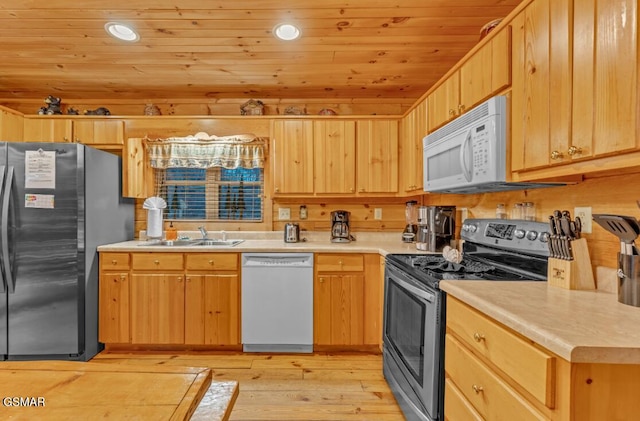 kitchen with appliances with stainless steel finishes, light wood-type flooring, sink, wooden ceiling, and wood walls