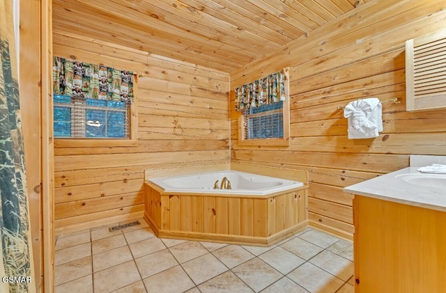 bathroom with tile patterned flooring, vanity, a bathtub, and wood walls