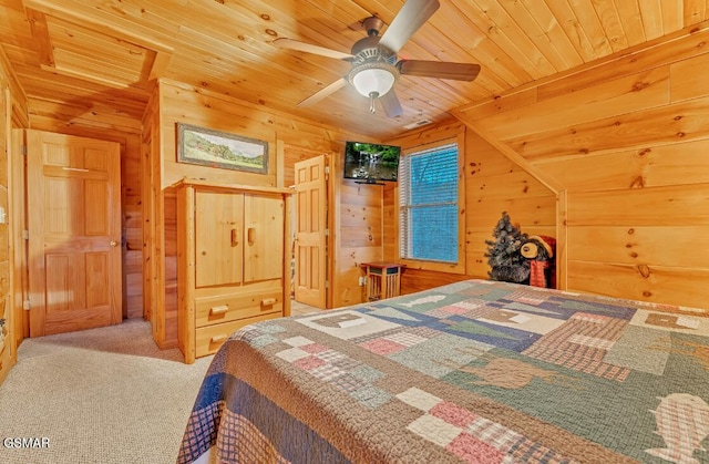 carpeted bedroom with lofted ceiling, ceiling fan, wooden walls, and wood ceiling