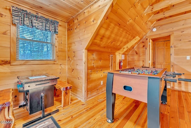 game room featuring light hardwood / wood-style floors, wood walls, wood ceiling, and vaulted ceiling