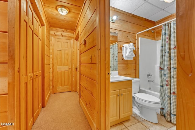 full bathroom with shower / bath combination with curtain, vanity, toilet, and wooden walls