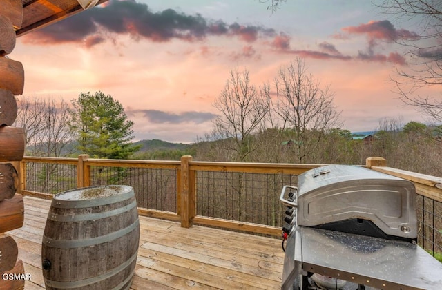 deck at dusk featuring grilling area