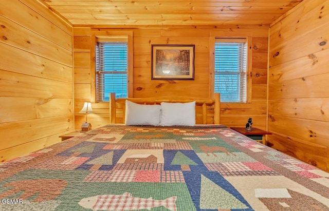 unfurnished bedroom with wood ceiling and wooden walls