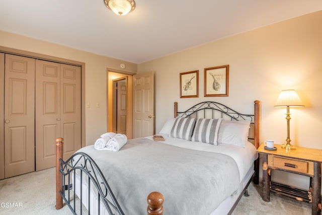 bedroom with a closet and light colored carpet