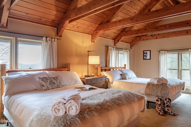 bedroom with lofted ceiling with beams, wooden ceiling, multiple windows, and carpet floors