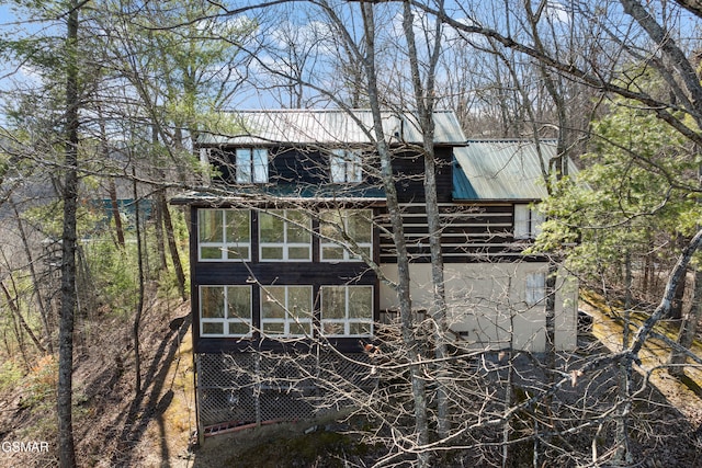 exterior space featuring metal roof and stucco siding