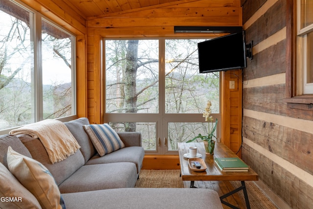 sunroom featuring lofted ceiling and wooden ceiling