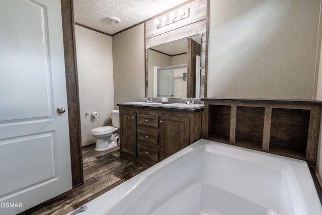 1138 Douglas Dam Rd, Dandridge, TN 37725 - bathroom featuring double vanity, wood finished floors, a textured ceiling, and a shower with shower door