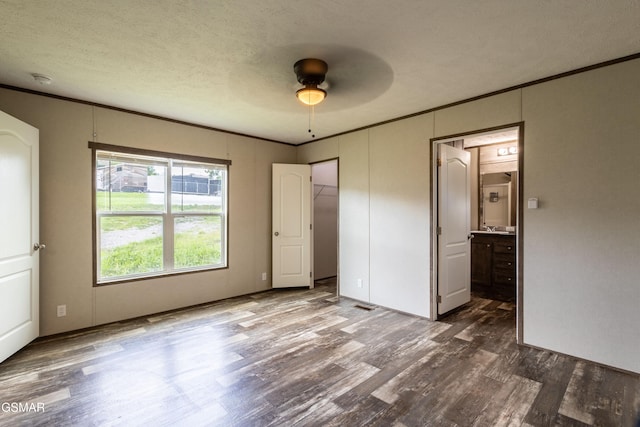 1138 Douglas Dam Rd, Dandridge, TN 37725 - unfurnished bedroom with dark wood-style floors, ornamental molding, connected bathroom, and ceiling fan