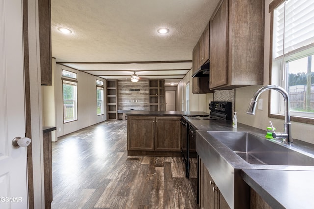 1138 Douglas Dam Rd, Dandridge, TN 37725 - kitchen featuring electric range, a textured ceiling, dark countertops, a peninsula, and dark wood finished floors
