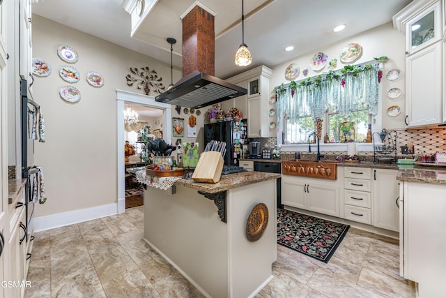 kitchen featuring a center island, white cabinetry, dark stone counters, and backsplash