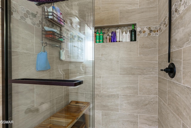 bathroom featuring a shower with shower door