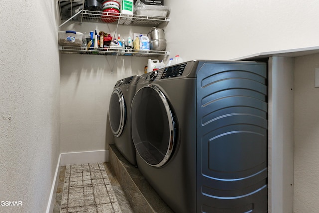 clothes washing area with washing machine and dryer