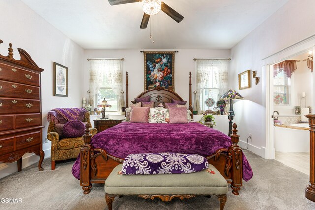 bedroom featuring multiple windows, ceiling fan, and light carpet