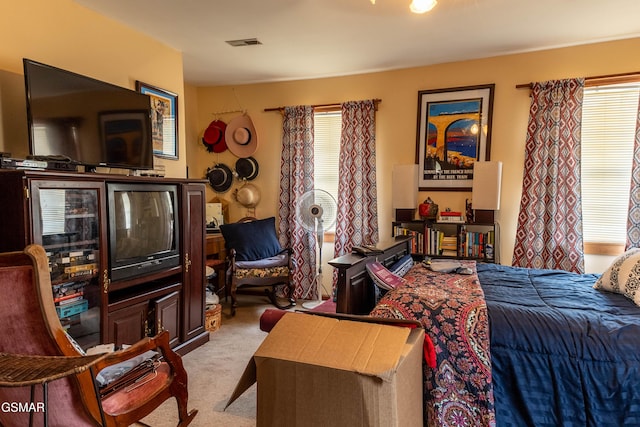 bedroom with visible vents and light colored carpet