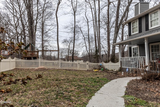 view of yard featuring fence private yard and covered porch