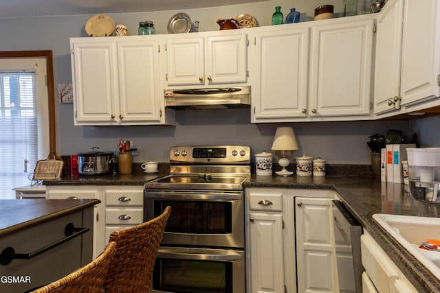 kitchen featuring stainless steel appliances, dark countertops, white cabinets, a sink, and under cabinet range hood