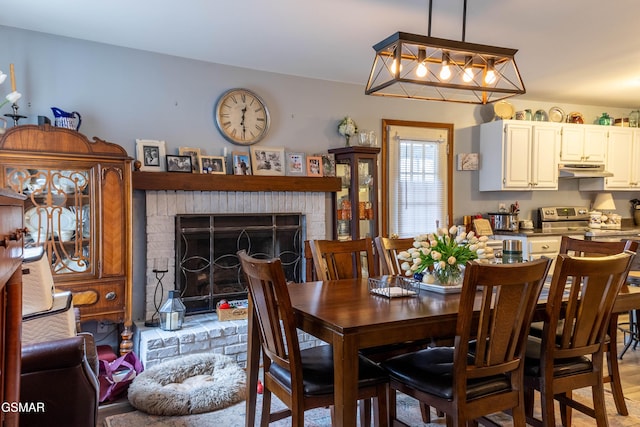 dining room featuring a brick fireplace