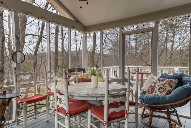 sunroom featuring vaulted ceiling