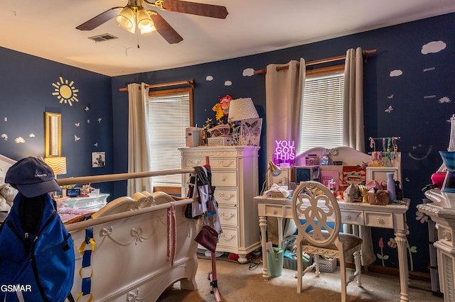 carpeted bedroom featuring visible vents and a ceiling fan