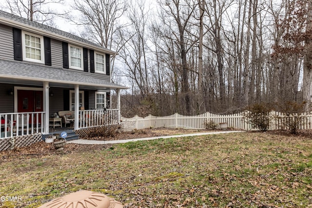 view of yard with a porch and fence