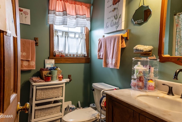 bathroom featuring vanity and toilet