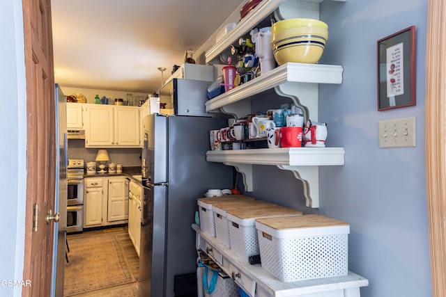 kitchen featuring appliances with stainless steel finishes and under cabinet range hood