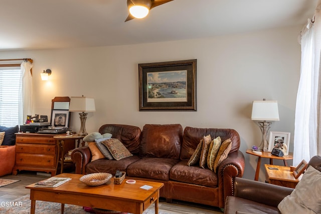 living room with wood finished floors and a ceiling fan