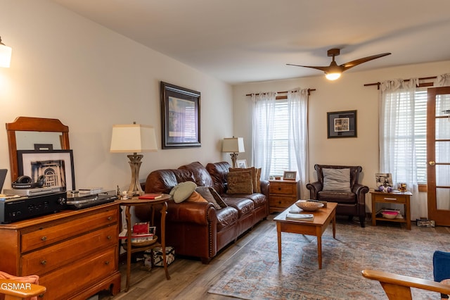 living room with ceiling fan and wood finished floors