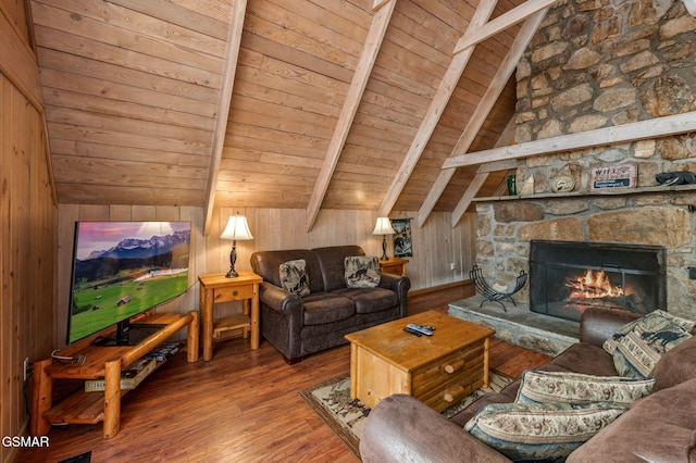 living room with a stone fireplace, vaulted ceiling with beams, wood ceiling, wooden walls, and hardwood / wood-style floors