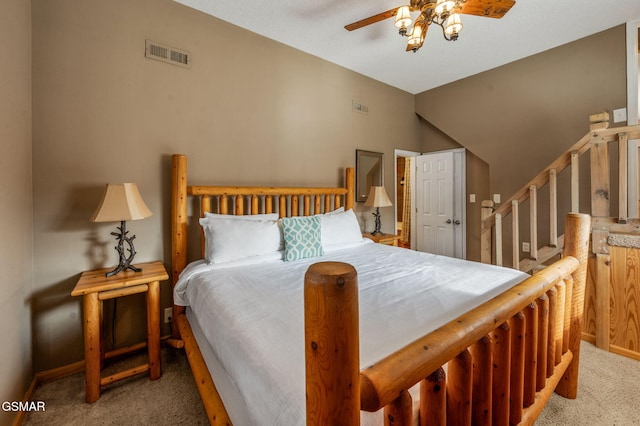 carpeted bedroom with ceiling fan and lofted ceiling