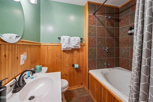 full bathroom with wooden walls, toilet, sink, and shower / bath combo