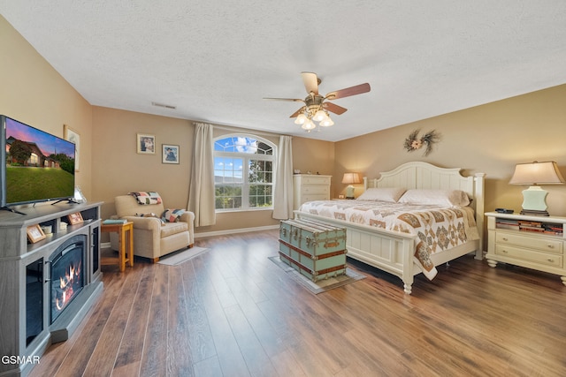 854 River Cliff Dr, Kodak, TN 37764 - bedroom with a textured ceiling, dark wood-style flooring, ceiling fan, and baseboards