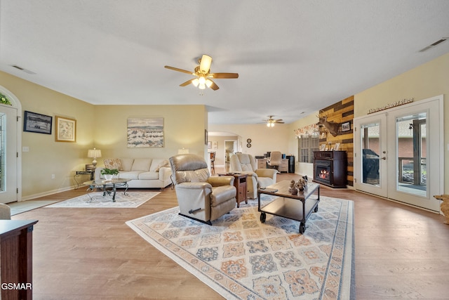 854 River Cliff Dr, Kodak, TN 37764 - living room featuring a ceiling fan, wood finished floors, arched walkways, and a warm lit fireplace
