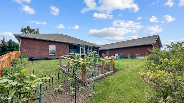 854 River Cliff Dr, Kodak, TN 37764 - rear view of property featuring a vegetable garden, brick siding, and a sunroom