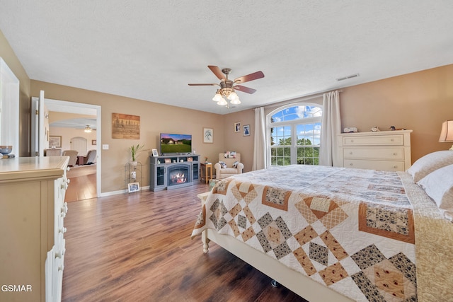 854 River Cliff Dr, Kodak, TN 37764 - bedroom featuring wood finished floors, baseboards, ceiling fan, and a textured ceiling