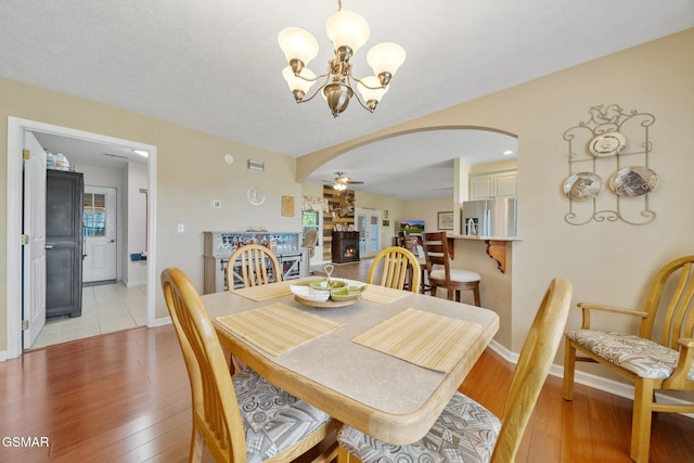854 River Cliff Dr, Kodak, TN 37764 - dining area featuring arched walkways, a chandelier, light wood-style floors, and baseboards