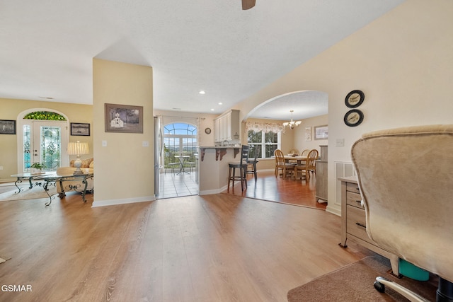854 River Cliff Dr, Kodak, TN 37764 - living area featuring light wood-style flooring, arched walkways, baseboards, a chandelier, and recessed lighting