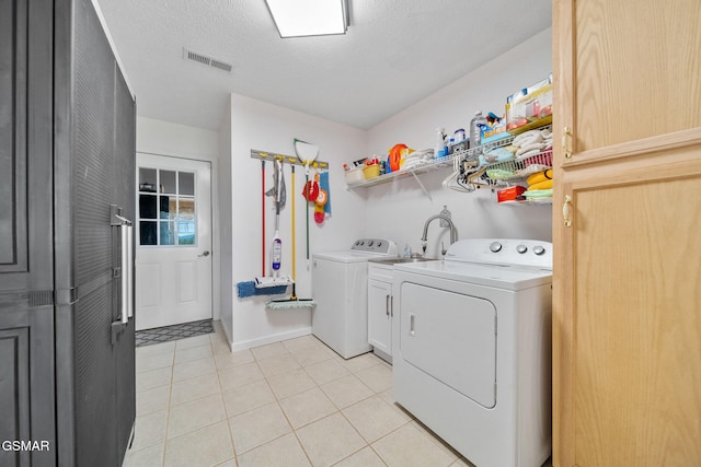 854 River Cliff Dr, Kodak, TN 37764 - washroom featuring cabinet space, washer and dryer, light tile patterned floors, and a textured ceiling