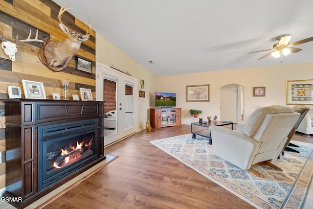 854 River Cliff Dr, Kodak, TN 37764 - living room featuring arched walkways, wood finished floors, a glass covered fireplace, and ceiling fan